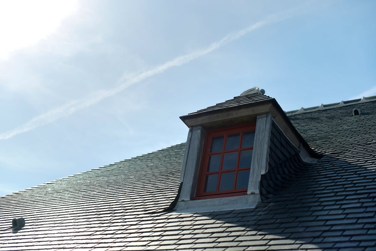 Roof renovation in progress on a residential property with scaffolding in place