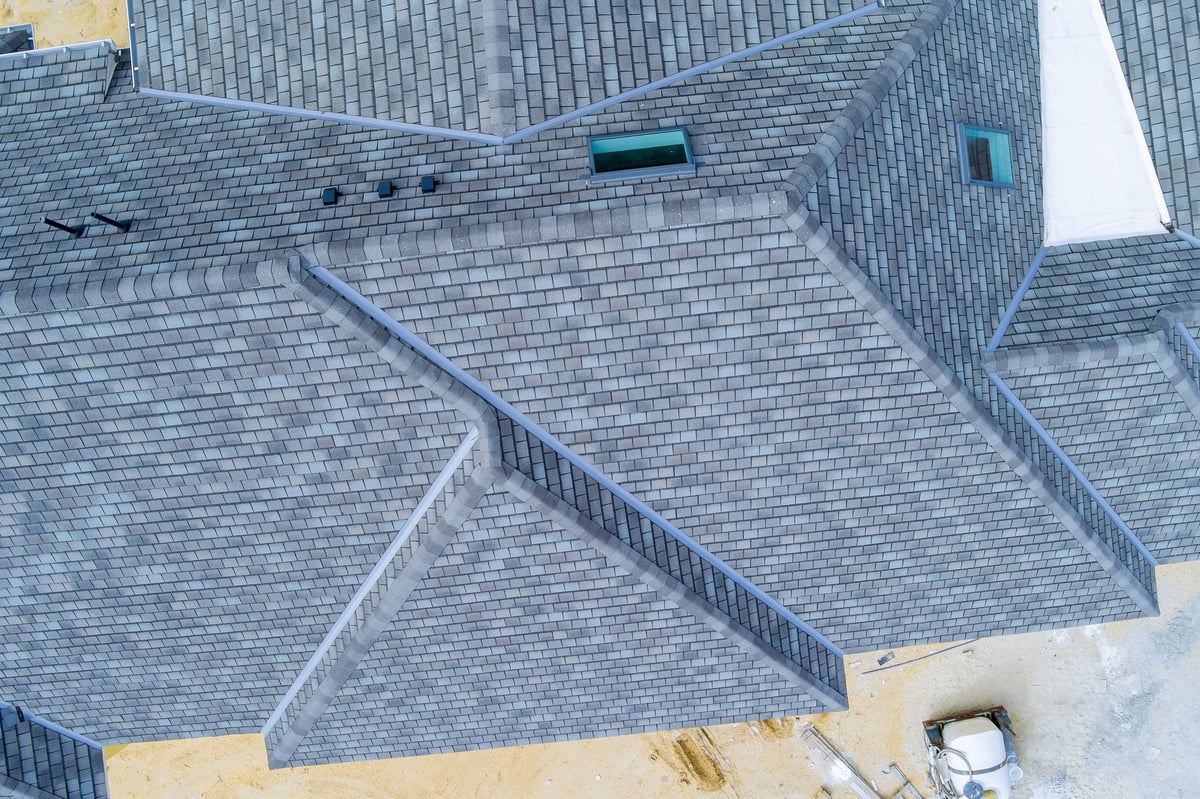 Overhead view of a newly completed house with a neat grey roof